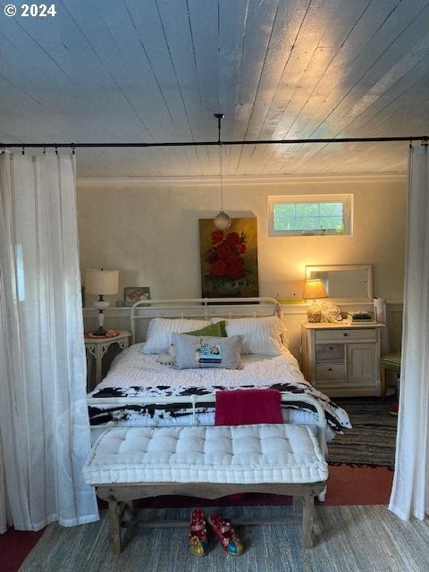 carpeted bedroom featuring wooden ceiling