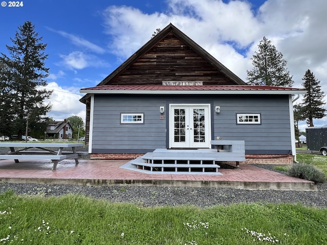 rear view of property with metal roof, french doors, and a patio area