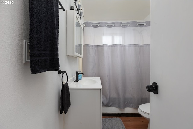 full bathroom featuring toilet, shower / bath combination with curtain, and vanity