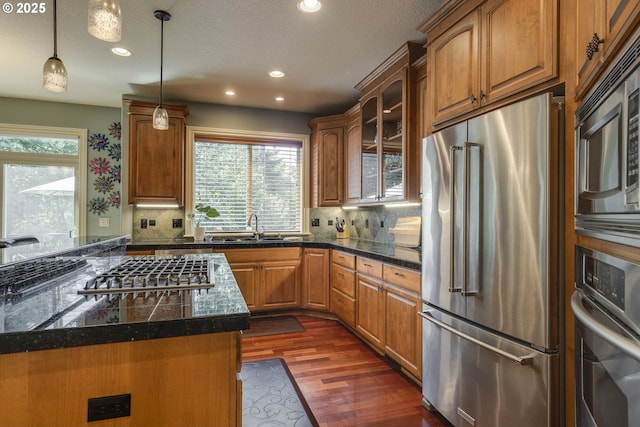 16572 SE Oak Meadow Ct, Damascus, OR 97089 - kitchen featuring appliances with stainless steel finishes, tile counters, dark wood-type flooring, glass insert cabinets, and recessed lighting