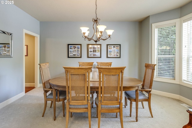 16572 SE Oak Meadow Ct, Damascus, OR 97089 - dining space featuring light colored carpet, a chandelier, and plenty of natural light