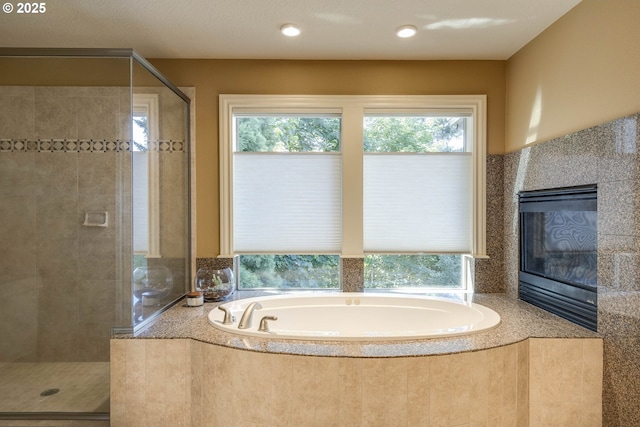 16572 SE Oak Meadow Ct, Damascus, OR 97089 - full bathroom with a garden tub, a stall shower, and a tile fireplace