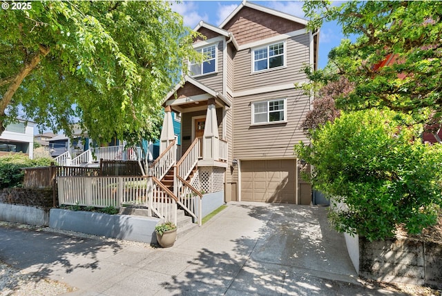 511 NE Skidmore St, Portland, OR 97211 - view of front of property with driveway, a garage, and covered porch