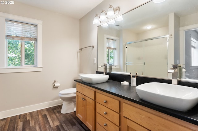 511 NE Skidmore St, Portland, OR 97211 - bathroom with double vanity, a stall shower, and wood finished floors