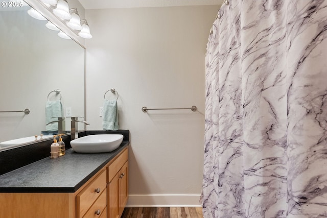 511 NE Skidmore St, Portland, OR 97211 - bathroom with vanity, wood finished floors, and a shower with shower curtain