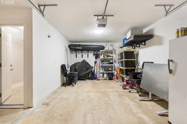 511 NE Skidmore St, Portland, OR 97211 - garage featuring a garage door opener and freestanding refrigerator