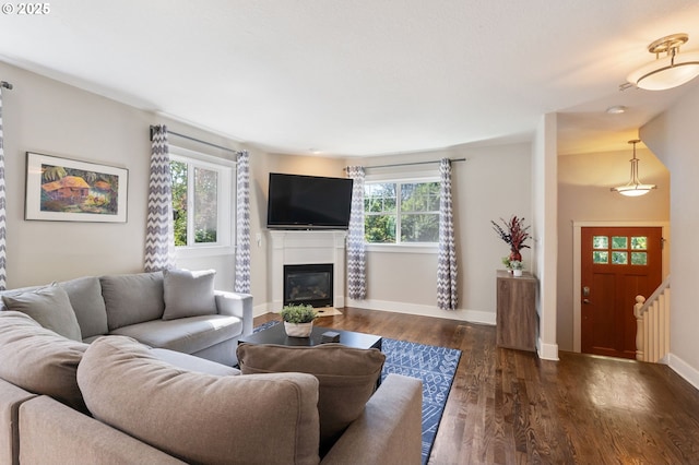 511 NE Skidmore St, Portland, OR 97211 - living area featuring plenty of natural light, dark wood-style flooring, and a glass covered fireplace