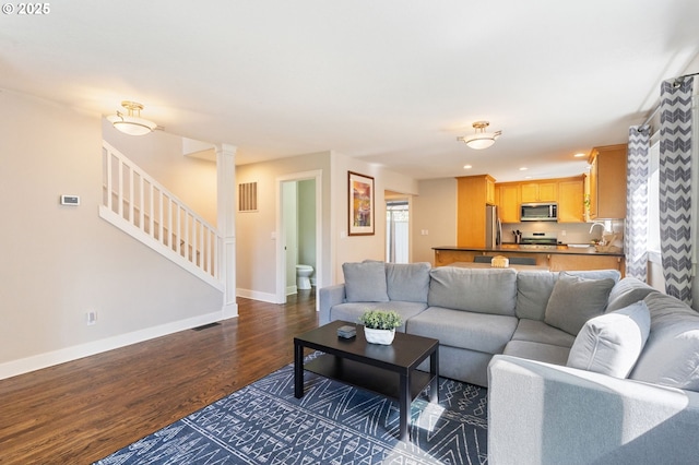 511 NE Skidmore St, Portland, OR 97211 - living room featuring dark wood-style floors, stairway, and recessed lighting