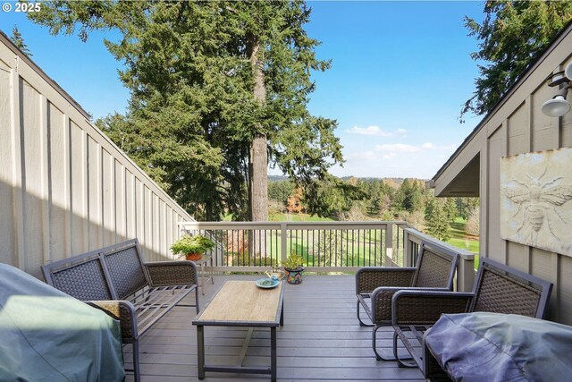 deck with an outdoor hangout area and grilling area