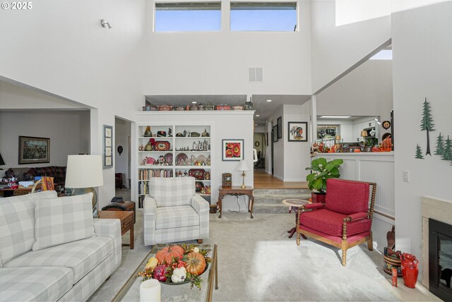 carpeted living room featuring lofted ceiling