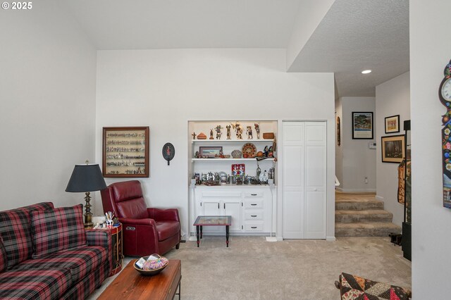 carpeted office space featuring lofted ceiling