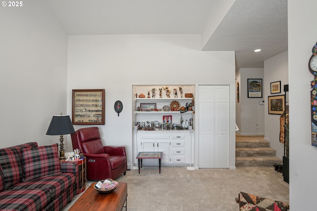 living room featuring light colored carpet and a textured ceiling