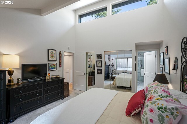 bedroom featuring high vaulted ceiling and light colored carpet