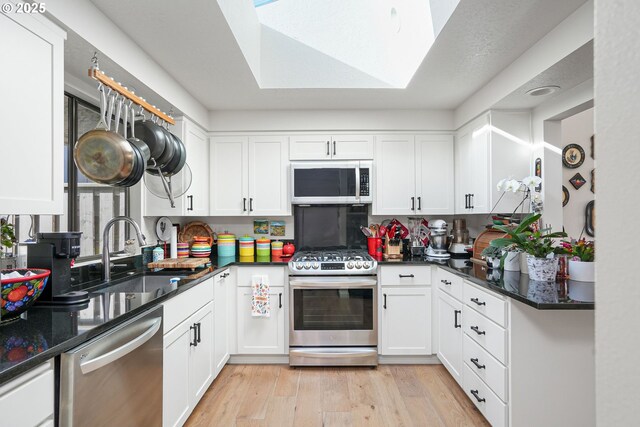 kitchen featuring sink, white cabinetry, and appliances with stainless steel finishes