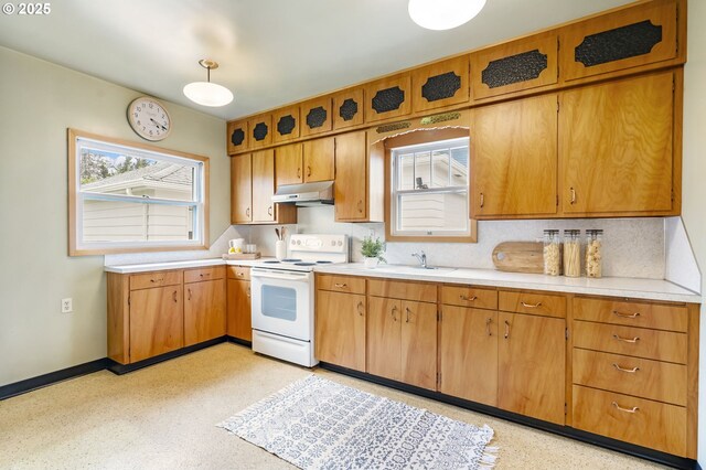 kitchen with electric stove, under cabinet range hood, a sink, light countertops, and baseboards