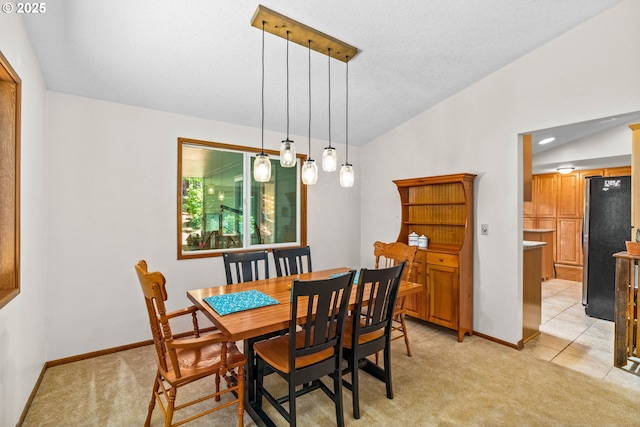 38383 Cartwright Creek Rd, Marcola, OR 97454 - dining room featuring light colored carpet, vaulted ceiling, and baseboards