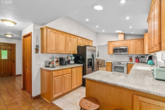38383 Cartwright Creek Rd, Marcola, OR 97454 - kitchen with stainless steel appliances, a peninsula, light tile patterned floors, tasteful backsplash, and light stone counters