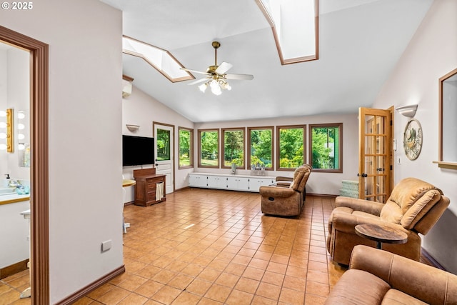 38383 Cartwright Creek Rd, Marcola, OR 97454 - living room featuring a skylight, lofted ceiling, a ceiling fan, light tile patterned floors, and baseboards