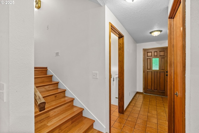38383 Cartwright Creek Rd, Marcola, OR 97454 - foyer featuring stairs, light tile patterned floors, a textured ceiling, and baseboards