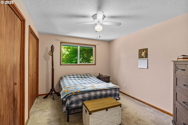38383 Cartwright Creek Rd, Marcola, OR 97454 - bedroom featuring light colored carpet, a textured ceiling, baseboards, ceiling fan, and a closet