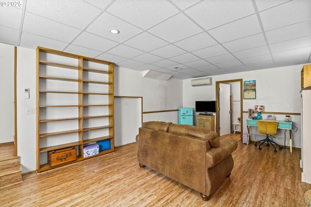 38383 Cartwright Creek Rd, Marcola, OR 97454 - living room with wood finished floors, a wall unit AC, a paneled ceiling, and recessed lighting