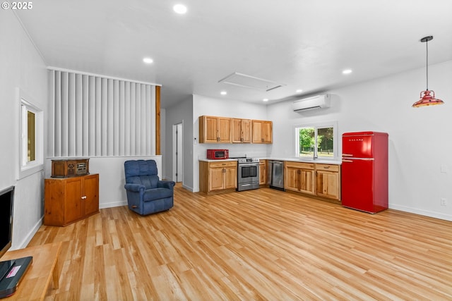 38383 Cartwright Creek Rd, Marcola, OR 97454 - kitchen with stainless steel appliances, a wall mounted air conditioner, light countertops, light wood-style floors, and recessed lighting