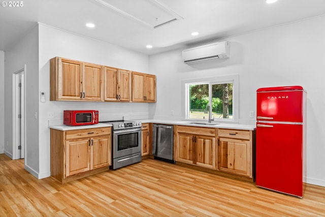 38383 Cartwright Creek Rd, Marcola, OR 97454 - kitchen with appliances with stainless steel finishes, a wall mounted AC, light wood finished floors, light countertops, and recessed lighting