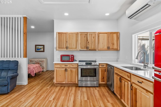 38383 Cartwright Creek Rd, Marcola, OR 97454 - kitchen with stainless steel appliances, a wall mounted AC, a sink, light wood-style floors, and light countertops