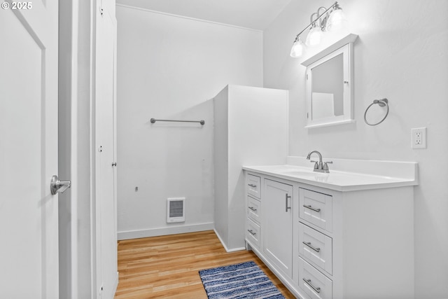 38383 Cartwright Creek Rd, Marcola, OR 97454 - bathroom with vanity, wood finished floors, heating unit, and baseboards