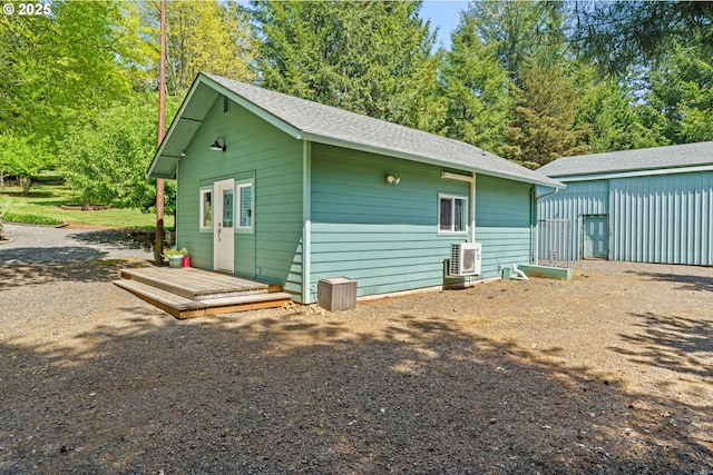 38383 Cartwright Creek Rd, Marcola, OR 97454 - view of home's exterior featuring a cooling unit, an outdoor structure, and a shingled roof