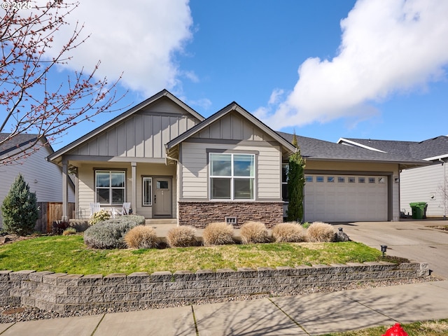 1461 Meadow Ave, Silverton, OR 97381 - view of front of home featuring stone siding, covered porch, an attached garage, board and batten siding, and driveway