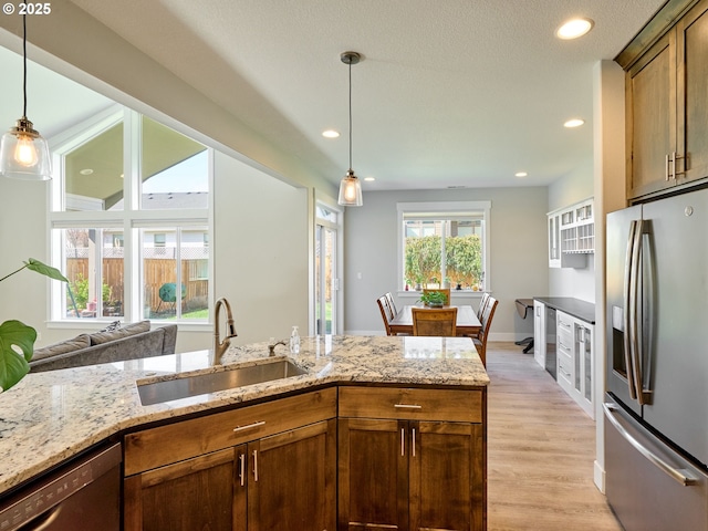 kitchen with dishwasher, a sink, decorative light fixtures, and stainless steel fridge with ice dispenser