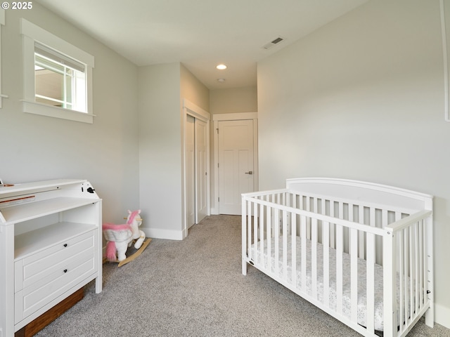 bedroom with carpet floors, recessed lighting, a closet, visible vents, and baseboards