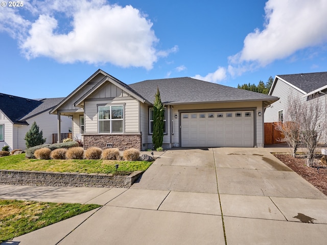 view of front of property featuring an attached garage, board and batten siding, fence, stone siding, and driveway