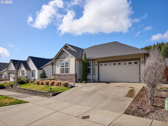 view of front of property featuring driveway, stone siding, roof with shingles, an attached garage, and board and batten siding