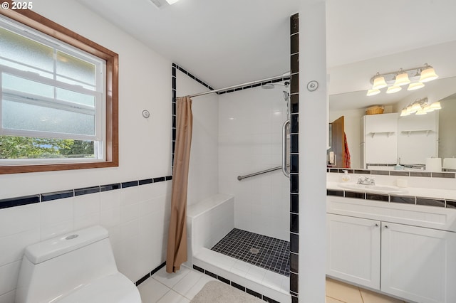 9065 Trask River Rd, Tillamook, OR 97141 - bathroom with a tile shower, vanity, tile walls, tile patterned flooring, and wainscoting