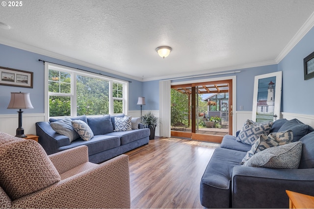 9065 Trask River Rd, Tillamook, OR 97141 - living room featuring ornamental molding, a wainscoted wall, and wood finished floors