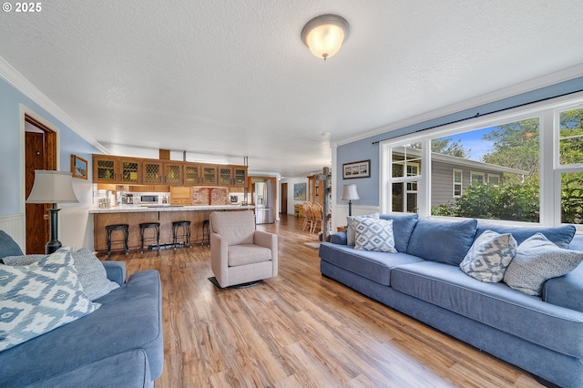 9065 Trask River Rd, Tillamook, OR 97141 - living room featuring ornamental molding, light wood finished floors, and a textured ceiling