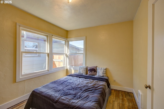 bedroom with hardwood / wood-style floors