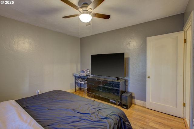 bedroom with hardwood / wood-style flooring and ceiling fan