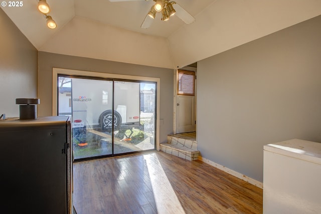 doorway to outside with hardwood / wood-style flooring, lofted ceiling, and ceiling fan