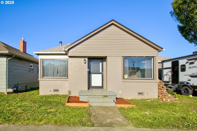 bungalow-style home with a front yard