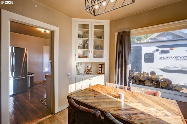 dining space with dark hardwood / wood-style flooring