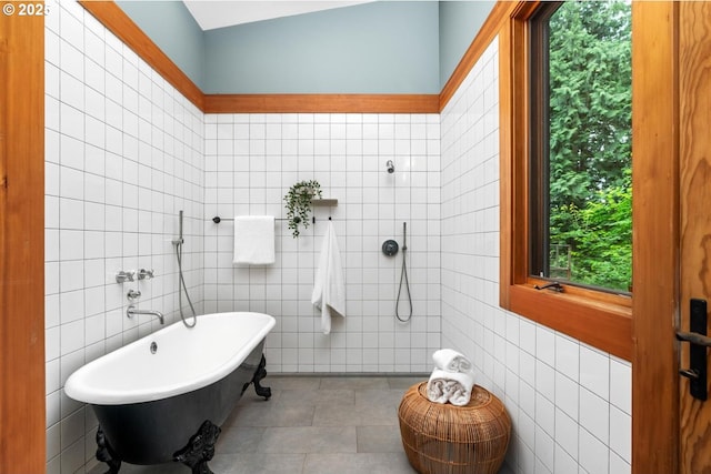full bath featuring tile walls, tiled shower, and a freestanding bath