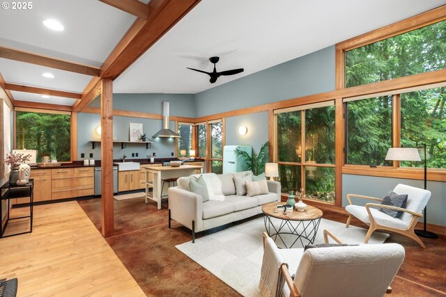 living room featuring healthy amount of natural light, ceiling fan, recessed lighting, and wood finished floors
