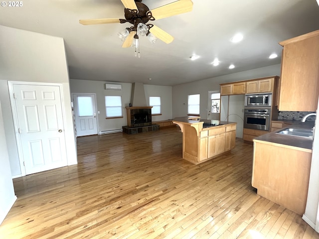 9949 Geneva View Rd, Terrebonne, OR 97760 - kitchen featuring appliances with stainless steel finishes, light wood-type flooring, a baseboard radiator, open floor plan, and a sink