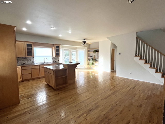9949 Geneva View Rd, Terrebonne, OR 97760 - kitchen with open floor plan, a sink, open shelves, backsplash, and hardwood / wood-style floors