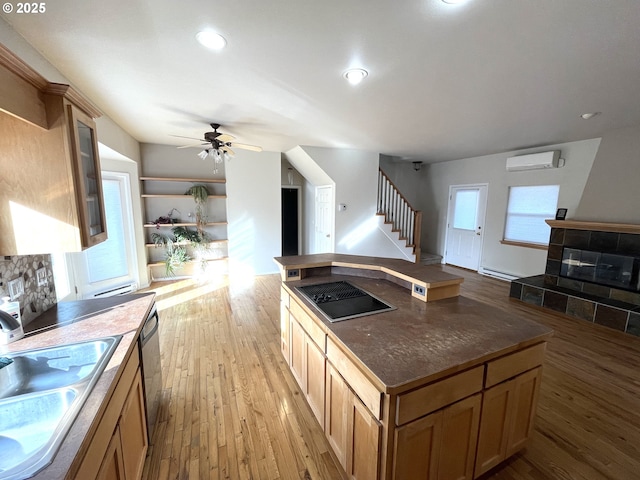 9949 Geneva View Rd, Terrebonne, OR 97760 - kitchen featuring a wall unit AC, a sink, a baseboard radiator, light wood finished floors, and recessed lighting