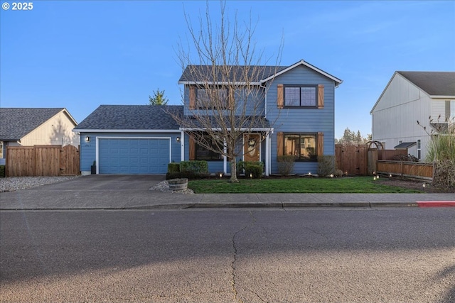 traditional-style house featuring a front yard, concrete driveway, an attached garage, and fence