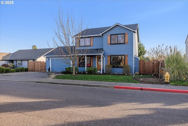 traditional home with a front yard, concrete driveway, a garage, and fence